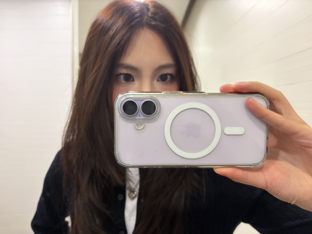 A mirror selfie with a purple phone