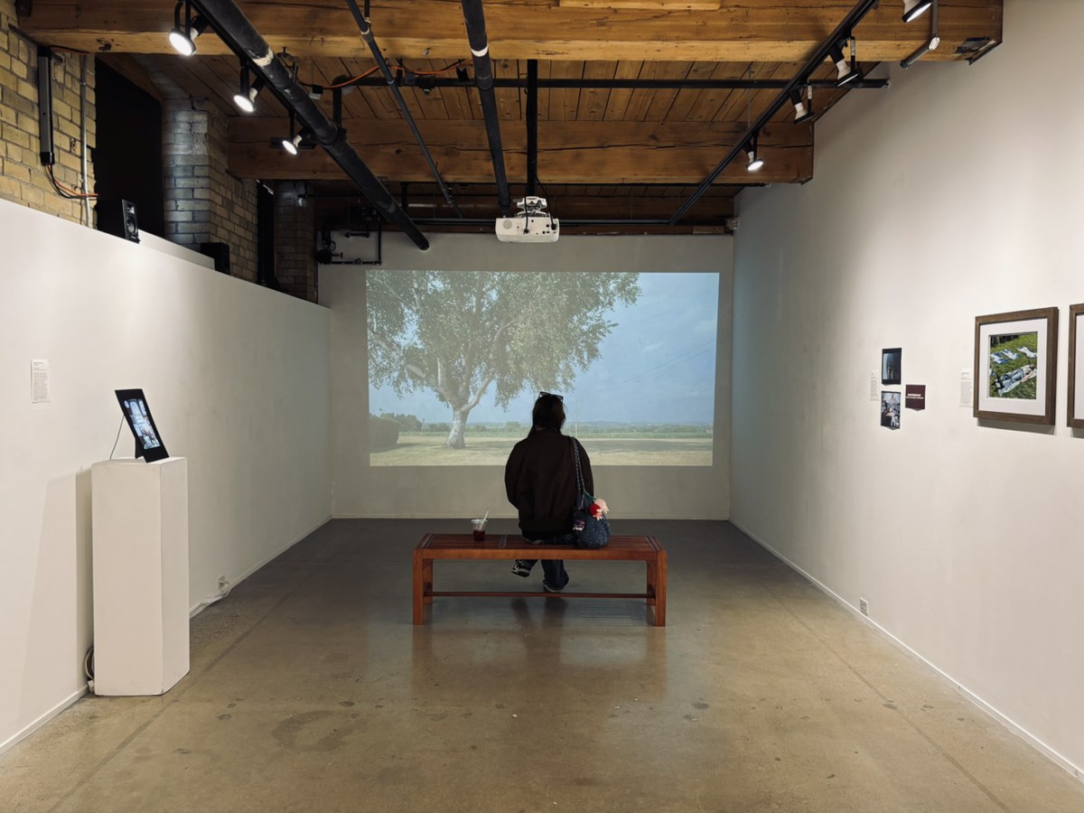 Yolanda sitting in an exhibition room
